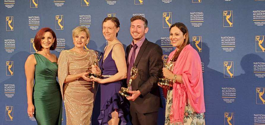 Group of people holding Emmy Awards