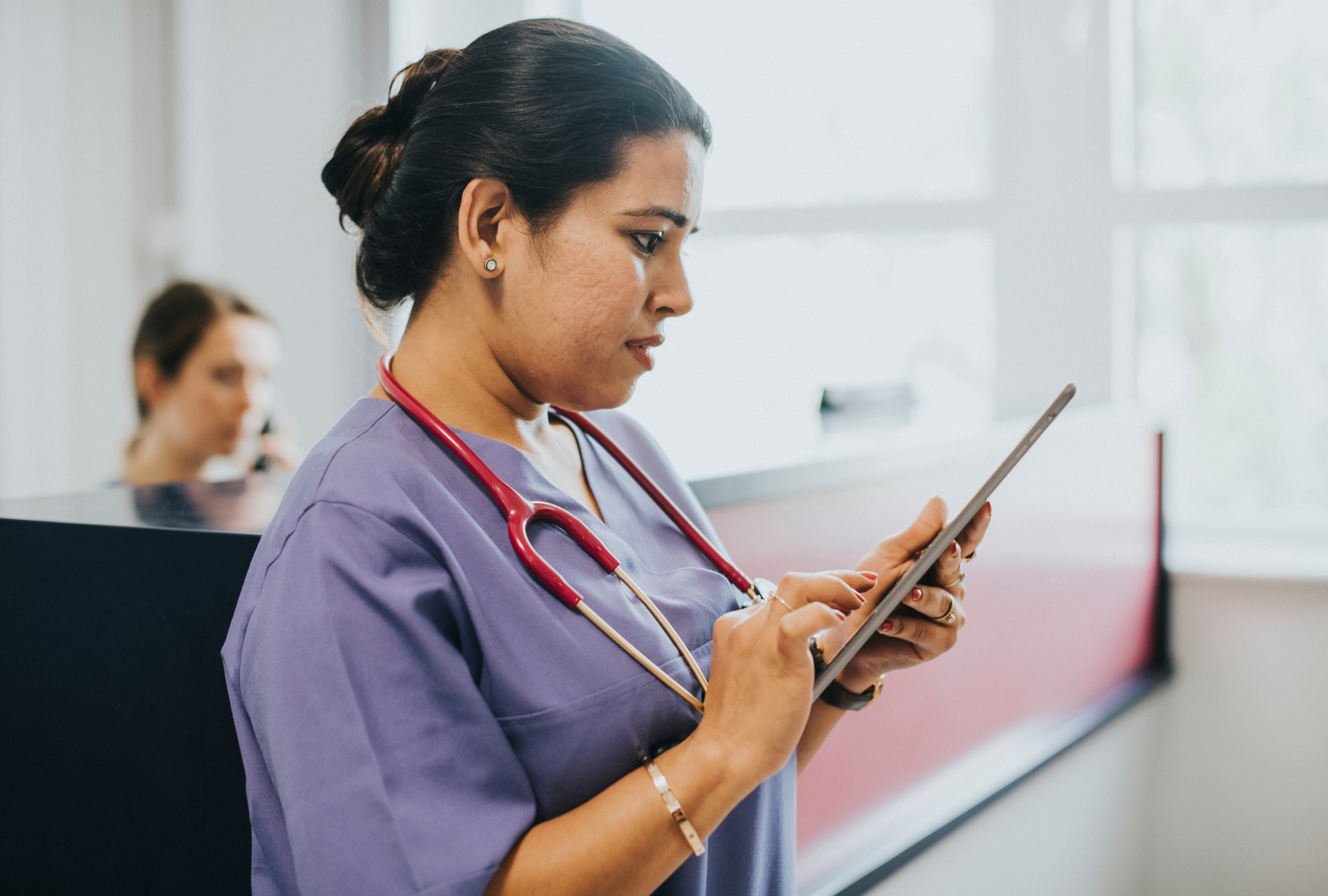 charting nurse with iPad